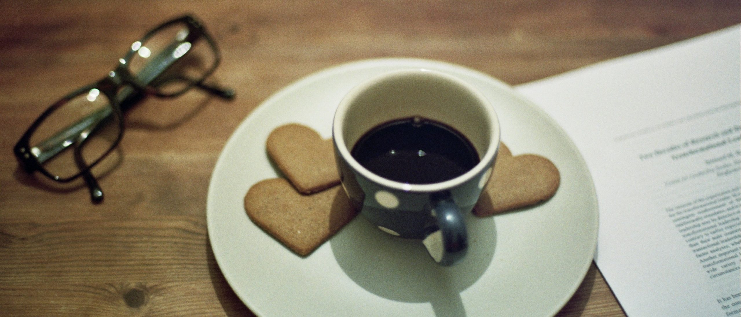 Coffee and cookies on desk with glasses